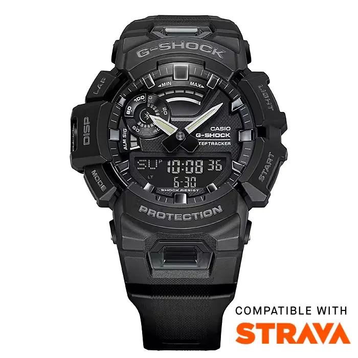 Vista frontal del reloj sobre fondo blanco con logotipo y texto de compatibilidad con Strava en la parte inferior.