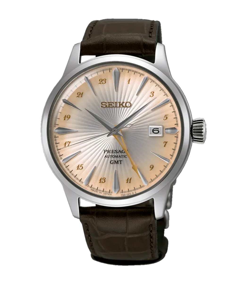 Full front view of the watch on a white background, brown leather strap and champagne dial
