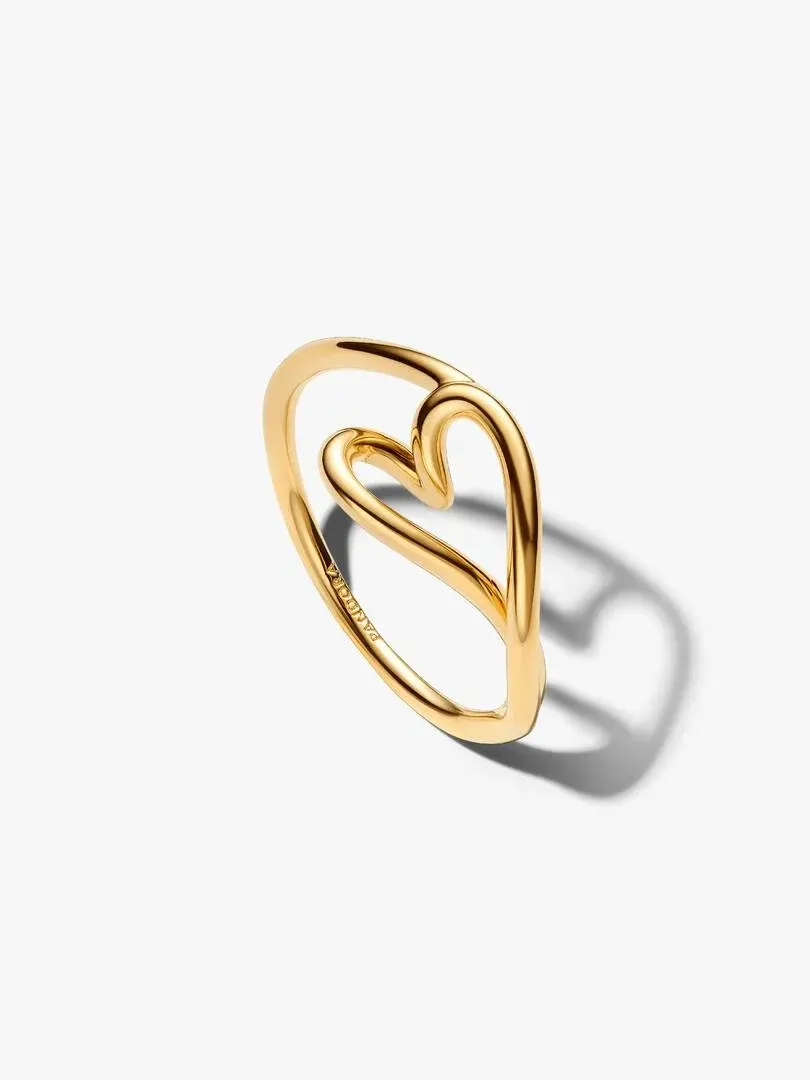 Organic heart ring shown from a side angle, gold-tone finish, on white background with soft shadow.