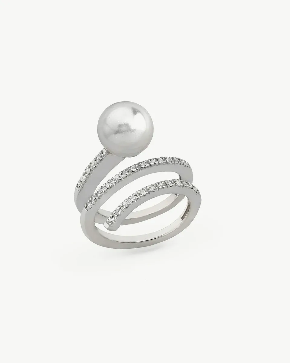 Spiral ring with pearl and cubic zirconia, side angle view on a white background.