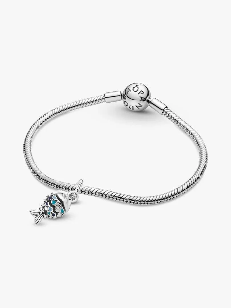 Blue fish charm on a silver snake chain bracelet, side view on white background.