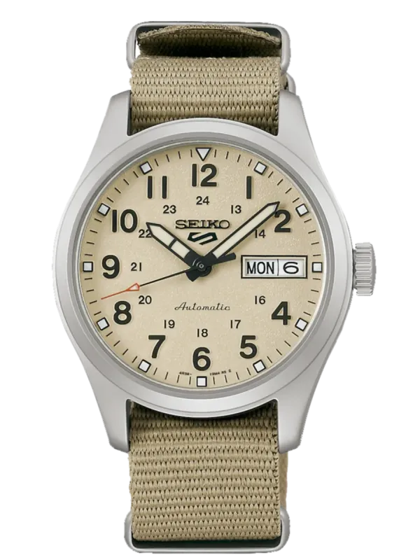 Vista frontal del reloj con esfera beige y correa de nylon, sobre fondo blanco.