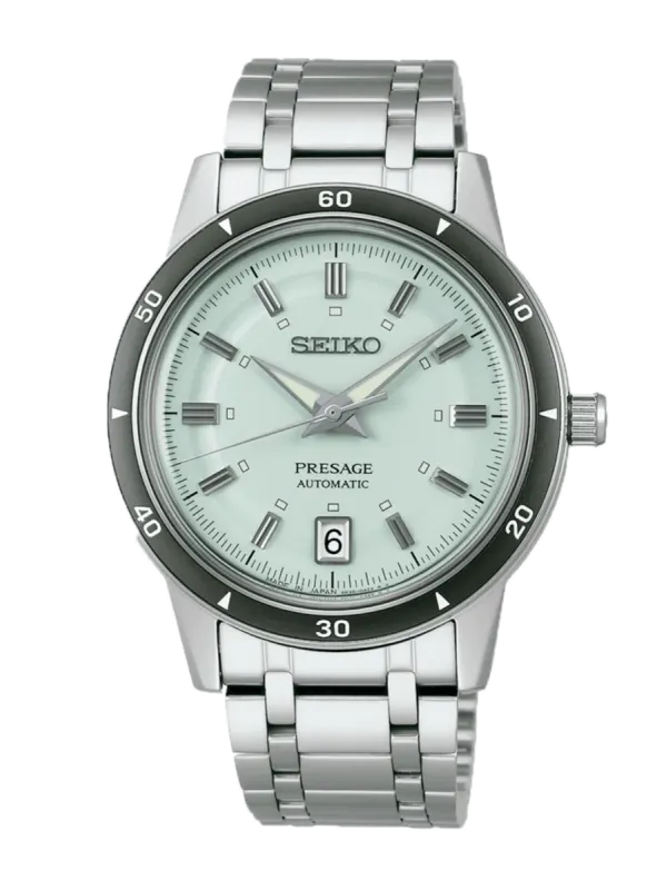 Vista frontal del reloj con esfera verde claro y brazalete de acero sobre fondo blanco.
