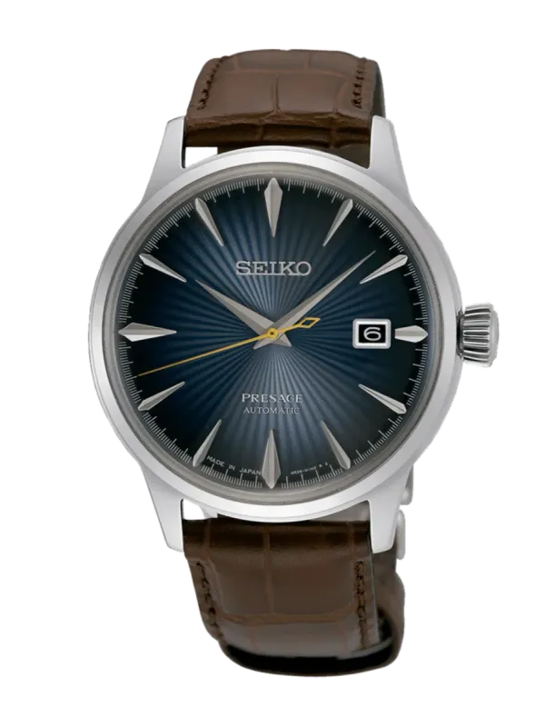 Vista frontal completa del reloj sobre fondo blanco, encuadre centrado con esfera azul y correa de piel marrón.