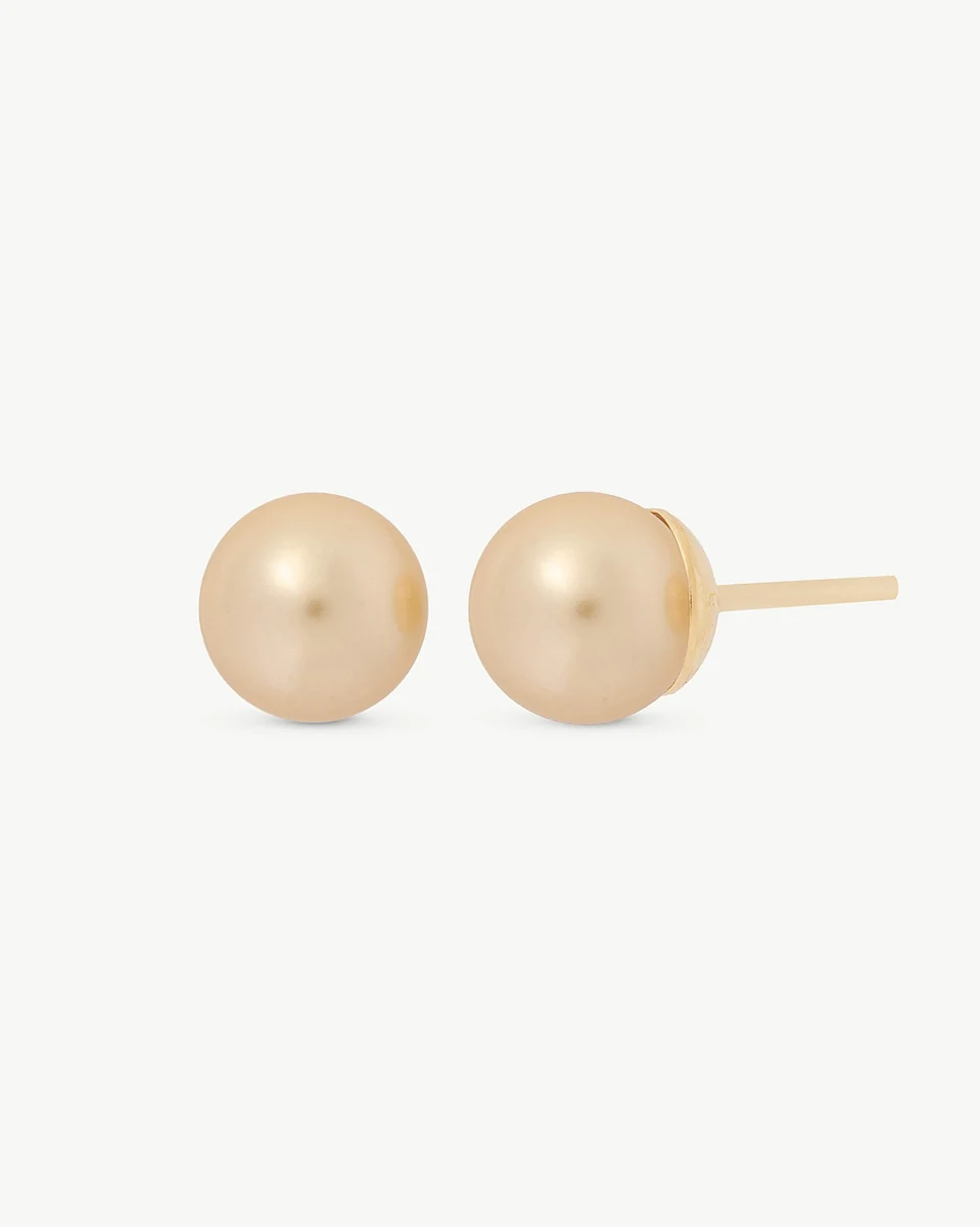 Pair of champagne pearl studs shown front and profile view, on a white background.
