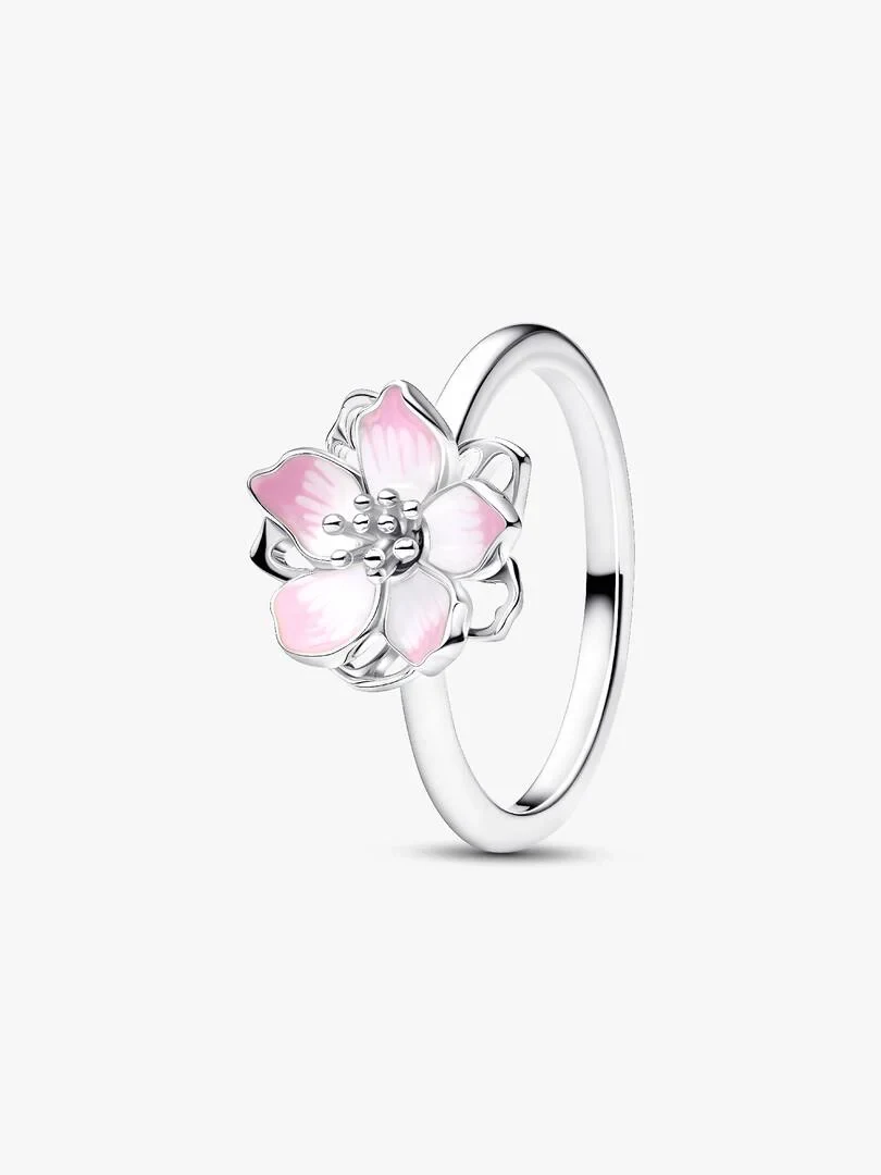 Cherry blossom ring with pink enamel shown from a side angle on a white background.