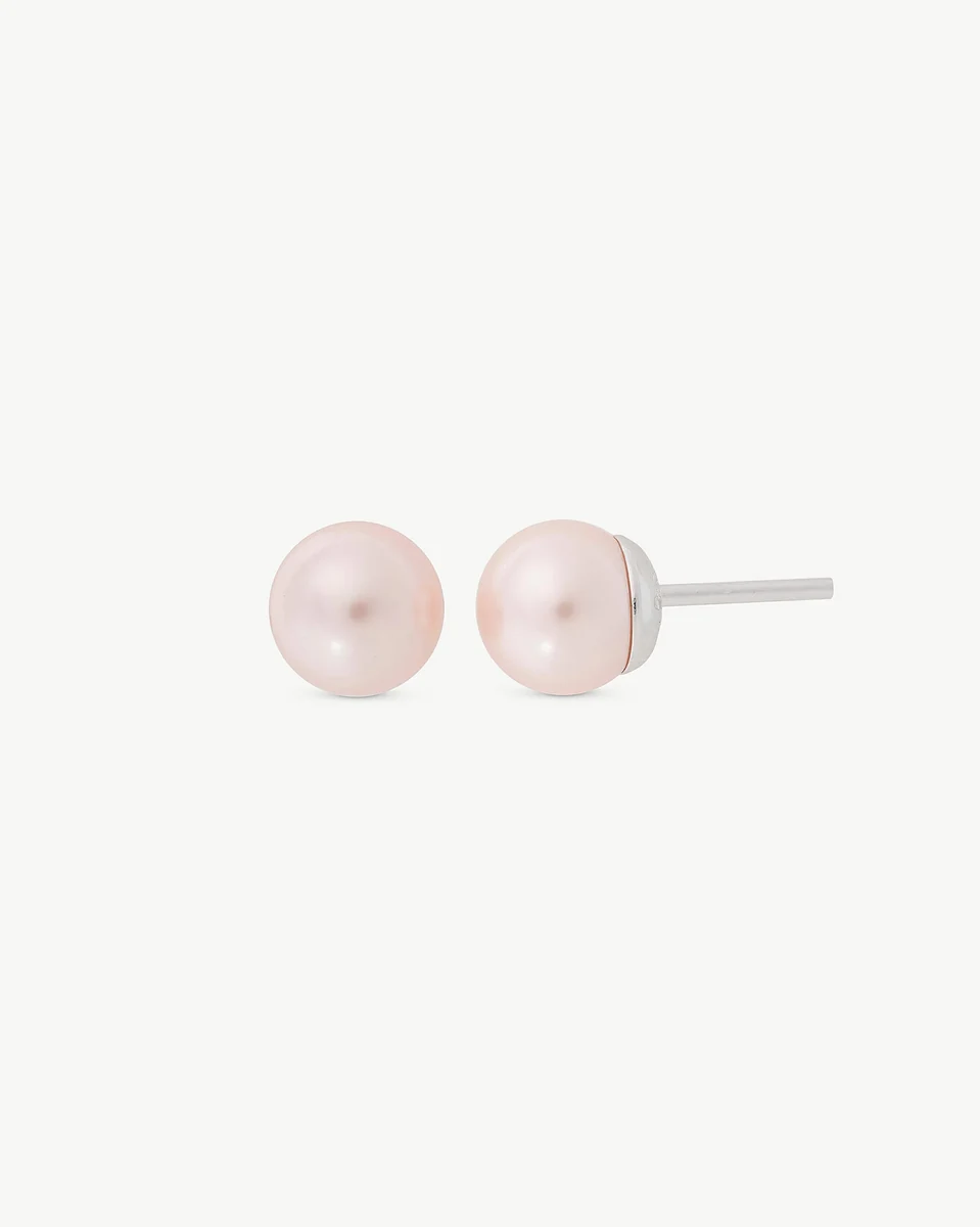 Front view of pink pearl stud earrings on a white background, showing the silver post profile.