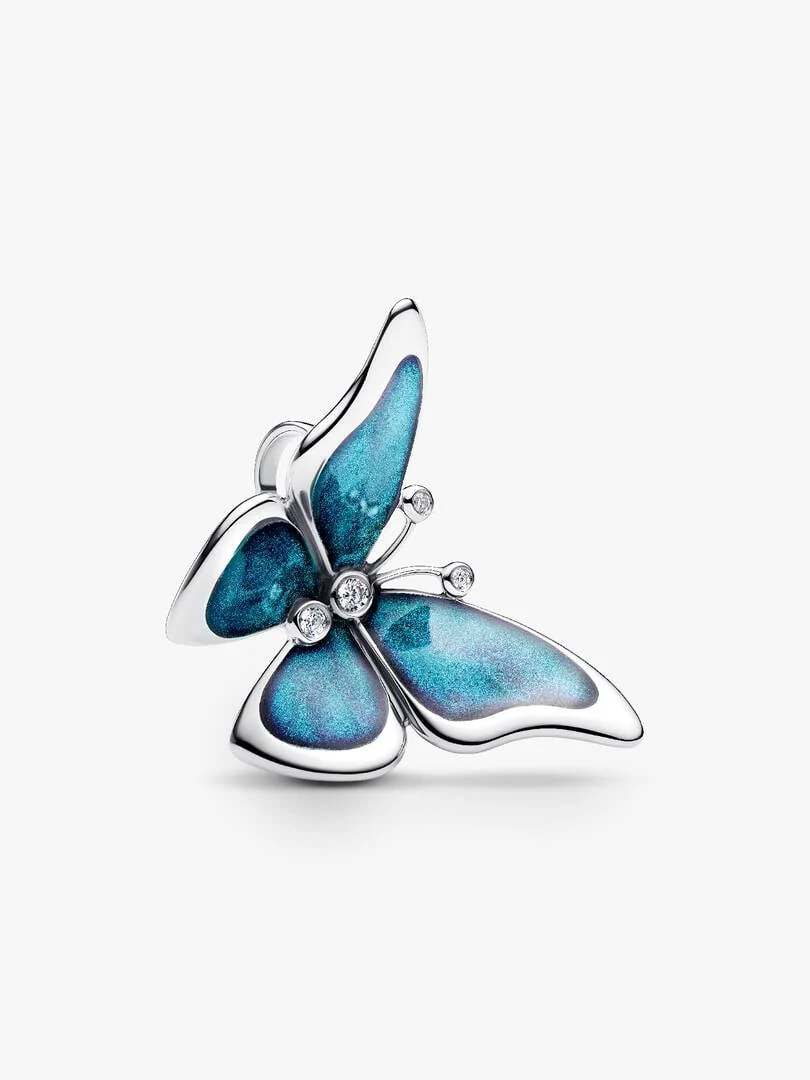 Charm papillon de profil sur fond blanc, mettant en valeur l'émail bleu et les zircons.