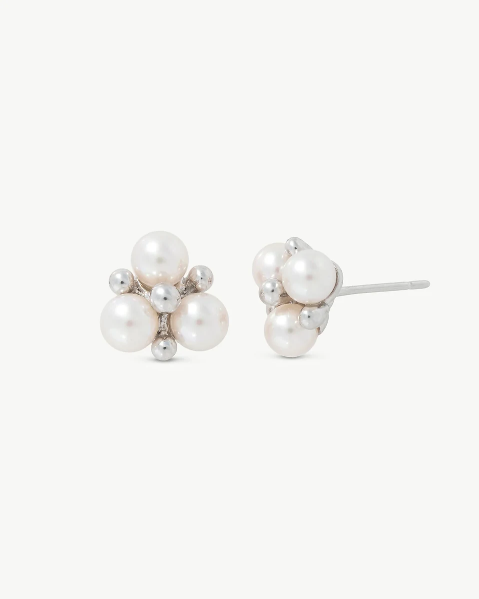 Front and side view of pearl earrings on a white background, showing the silver post.