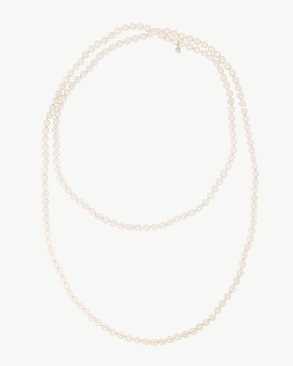 Pearl necklace arranged in two loops on a white background, full frontal view.