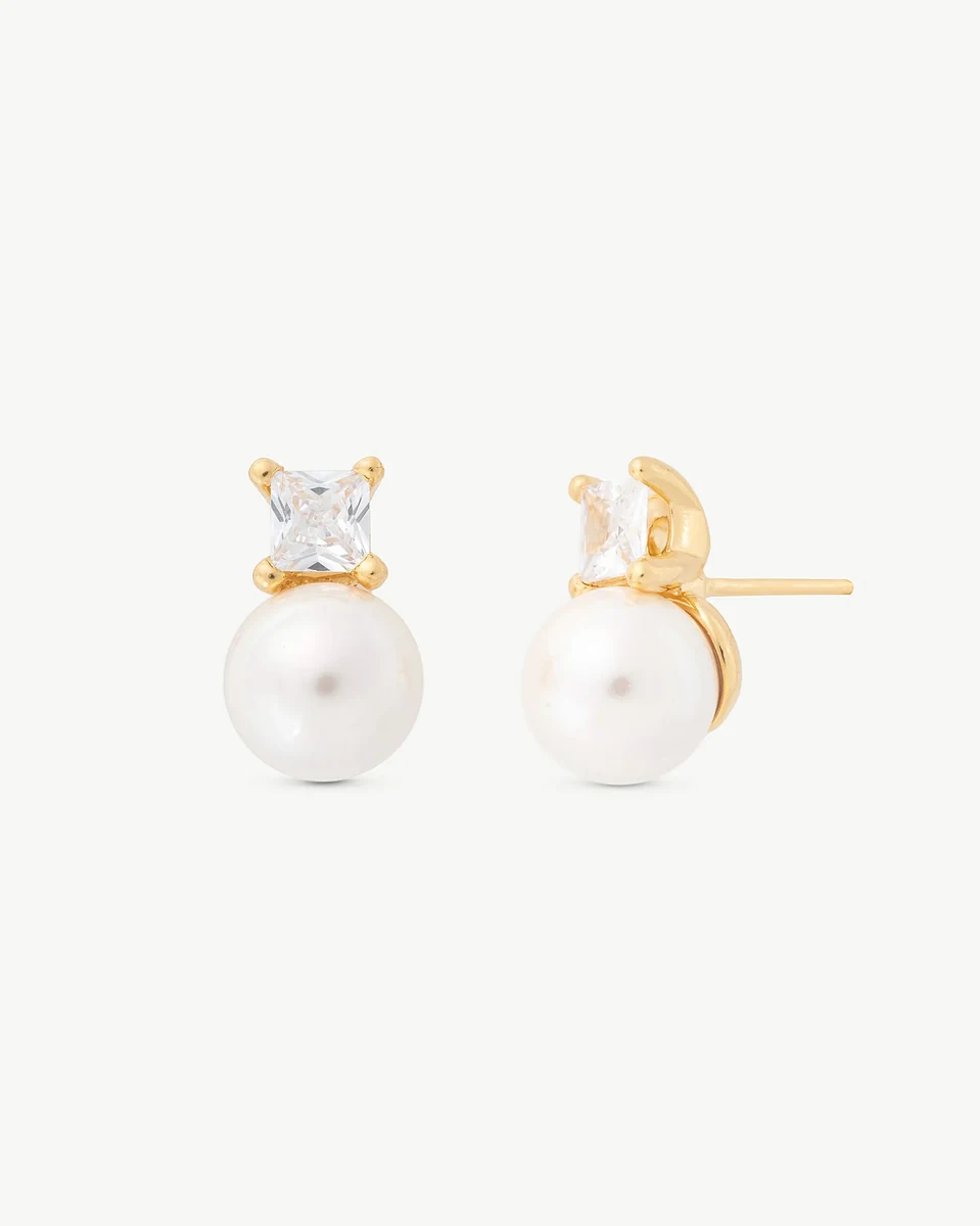 Pair of pearl and cubic zirconia stud earrings, front and profile view, on white background.