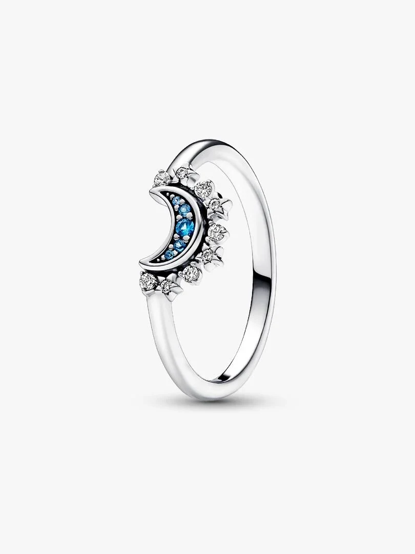 Crescent moon ring with blue pavé and stars, side angle view on a white background.