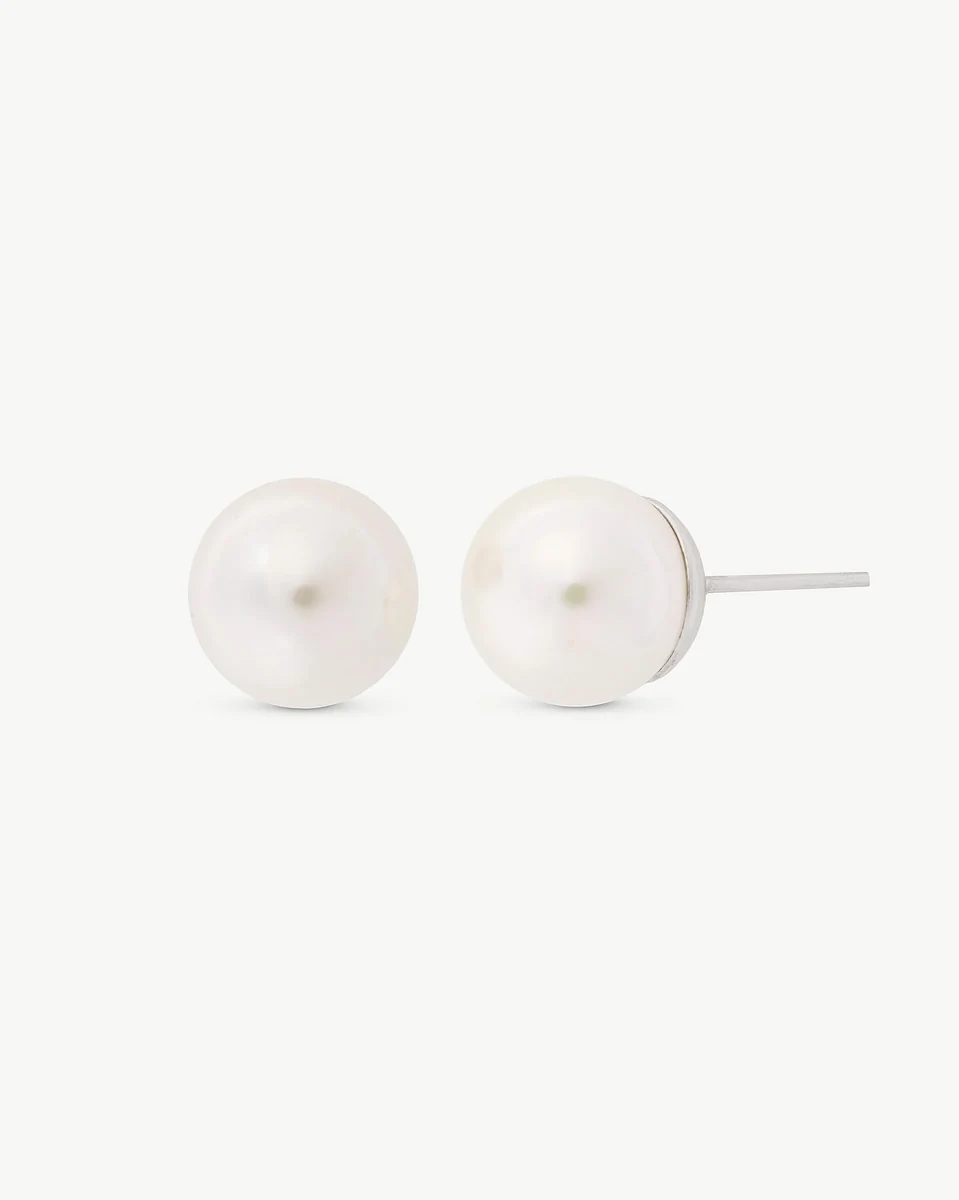 Front view of white pearl stud earrings on a white background, showing the side post.