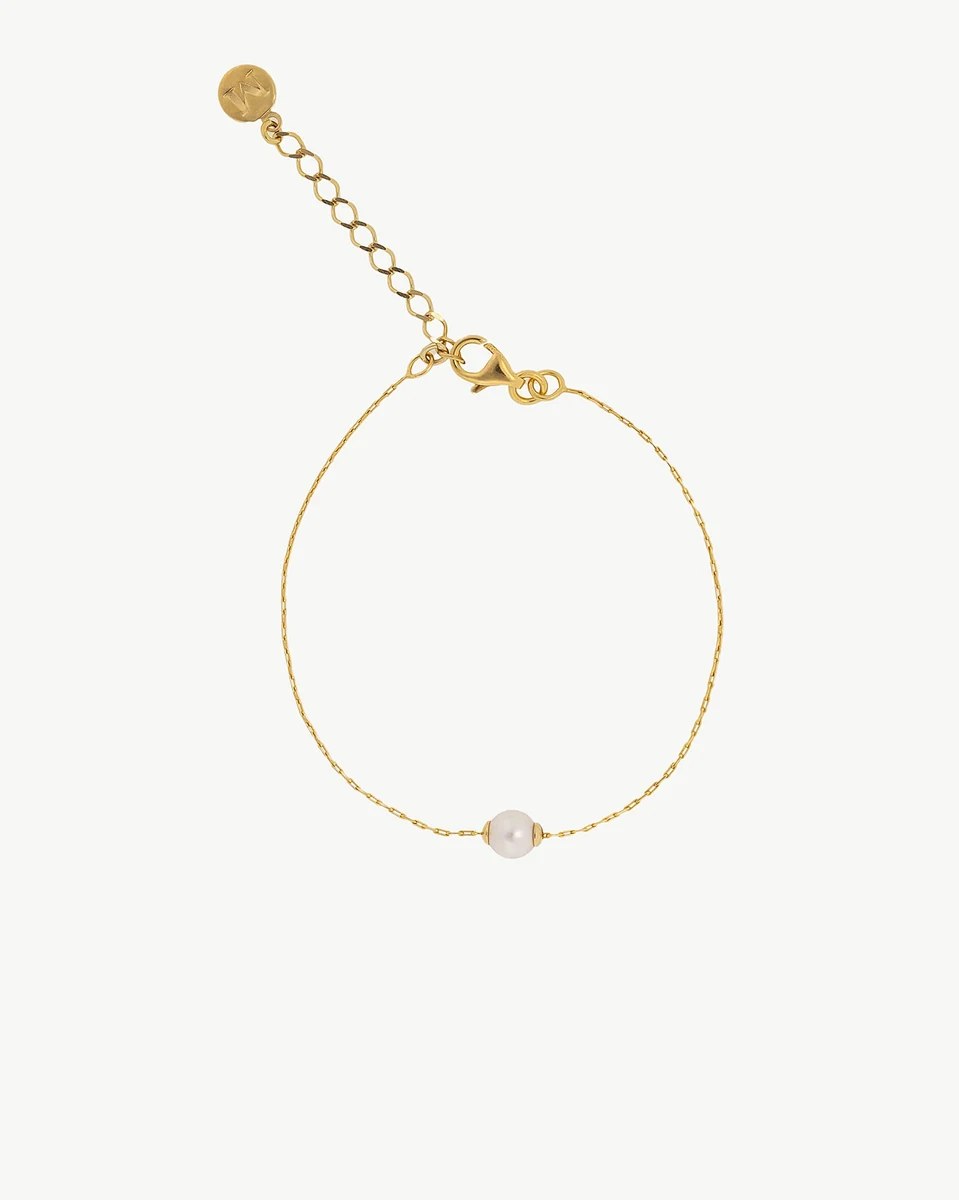 Gold bracelet with white pearl viewed from the front on a white background, showing the clasp and extender chain.