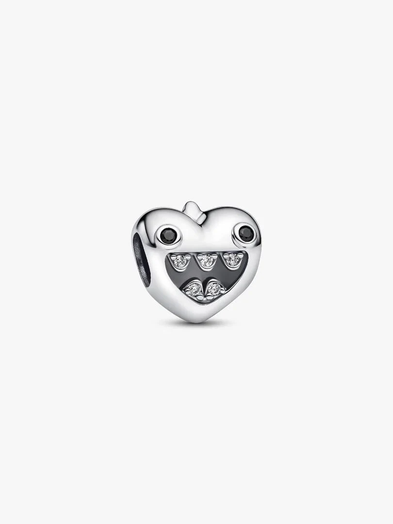 Heart-shaped charm with monster details and cubic zirconia, front view on white background.