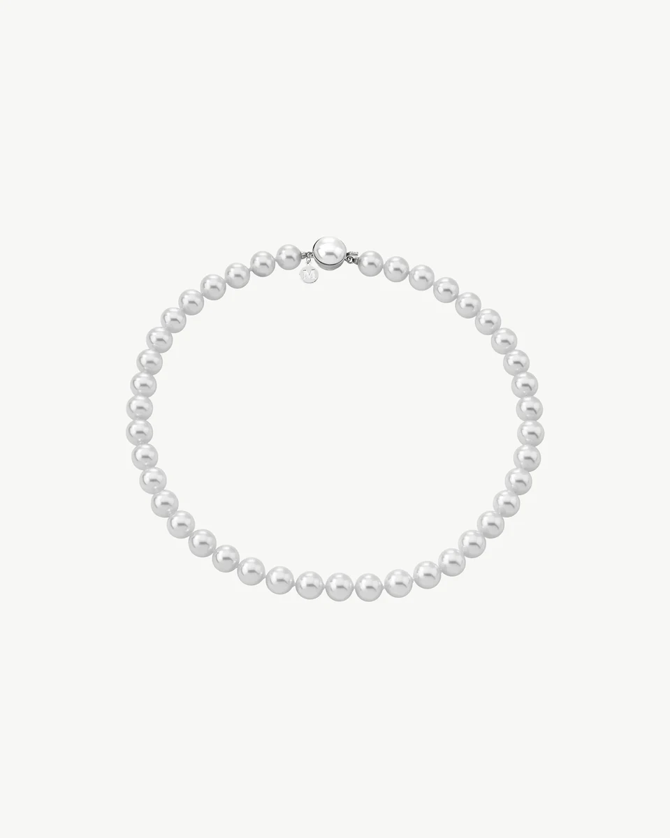 White pearl necklace arranged in a circle on a white background, full frontal view.