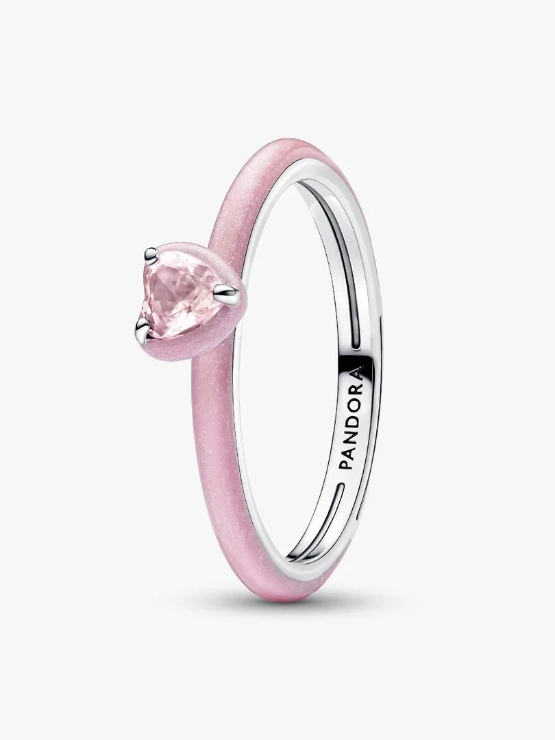 Silver ring with pink heart-shaped crystal, side angle view on a white background.