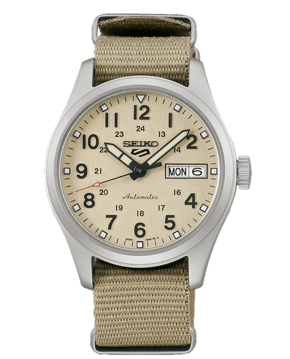 Vista frontal del reloj con esfera beige y correa de nylon, sobre fondo blanco.