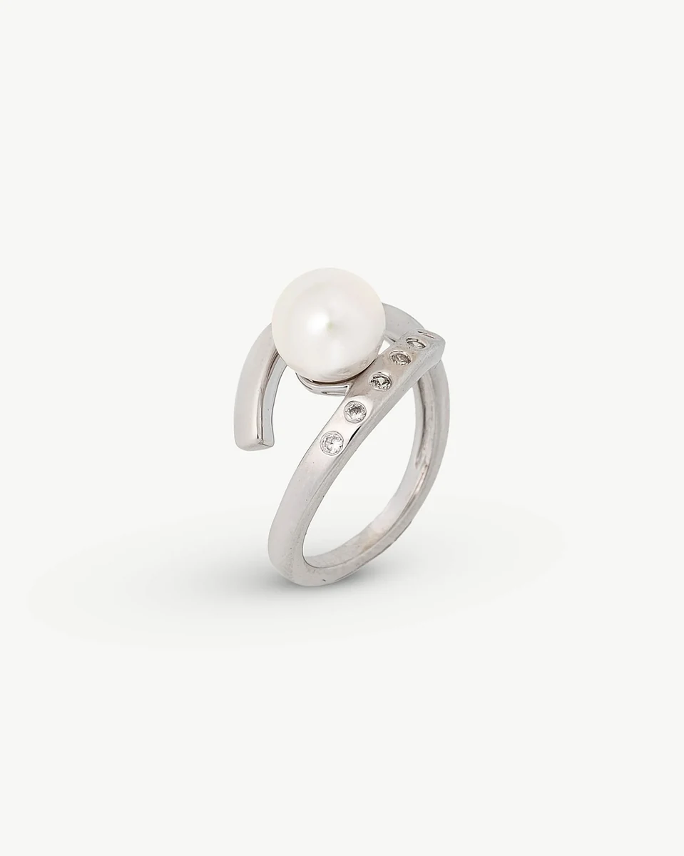 Silver ring with central pearl and cubic zirconia, angled view on white background.