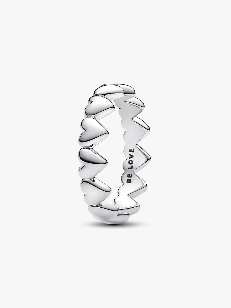 Silver heart ring shown from a side angle on a white background, featuring the 'BE LOVE' engraving inside.