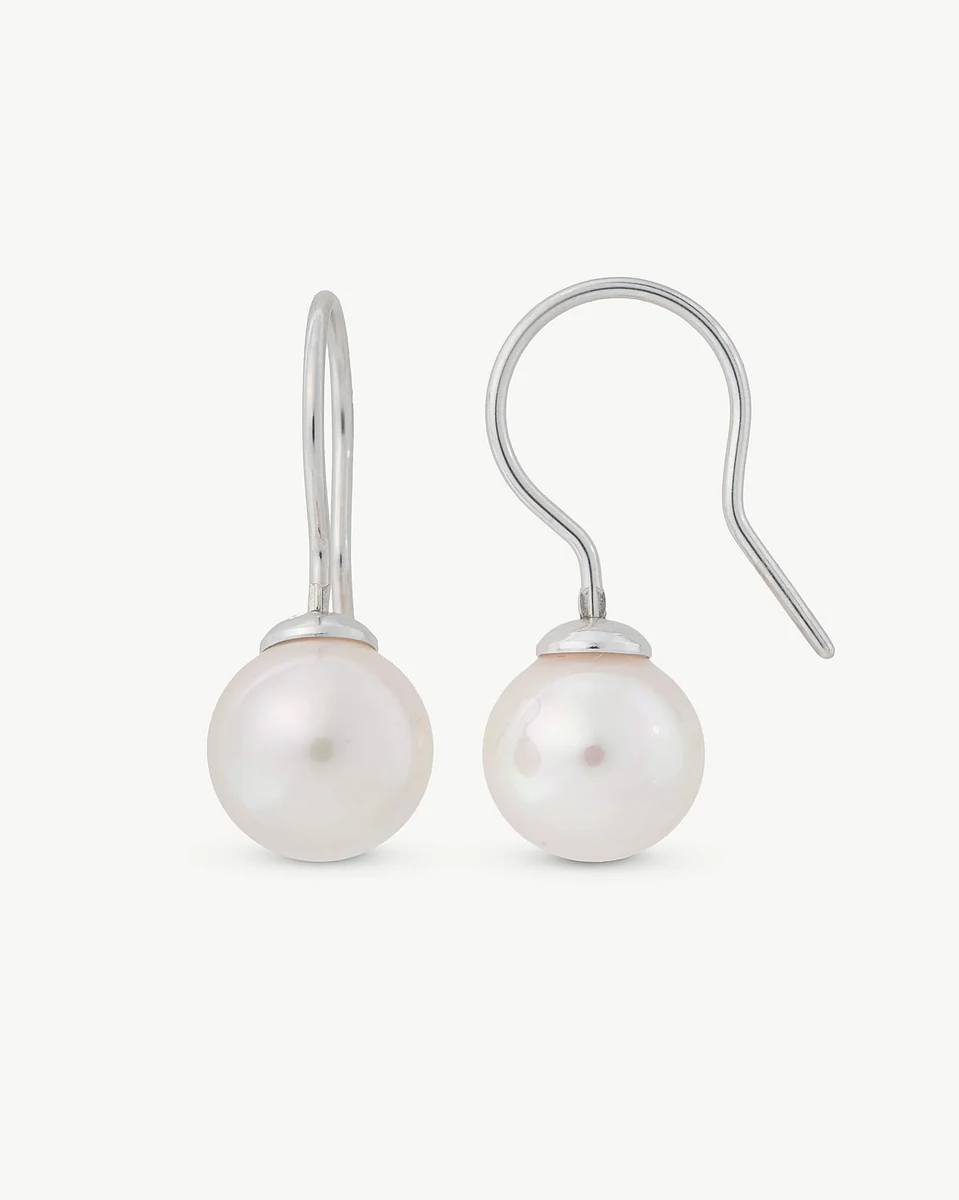 Front view of pearl drop earrings with hook closures, isolated on a white background.