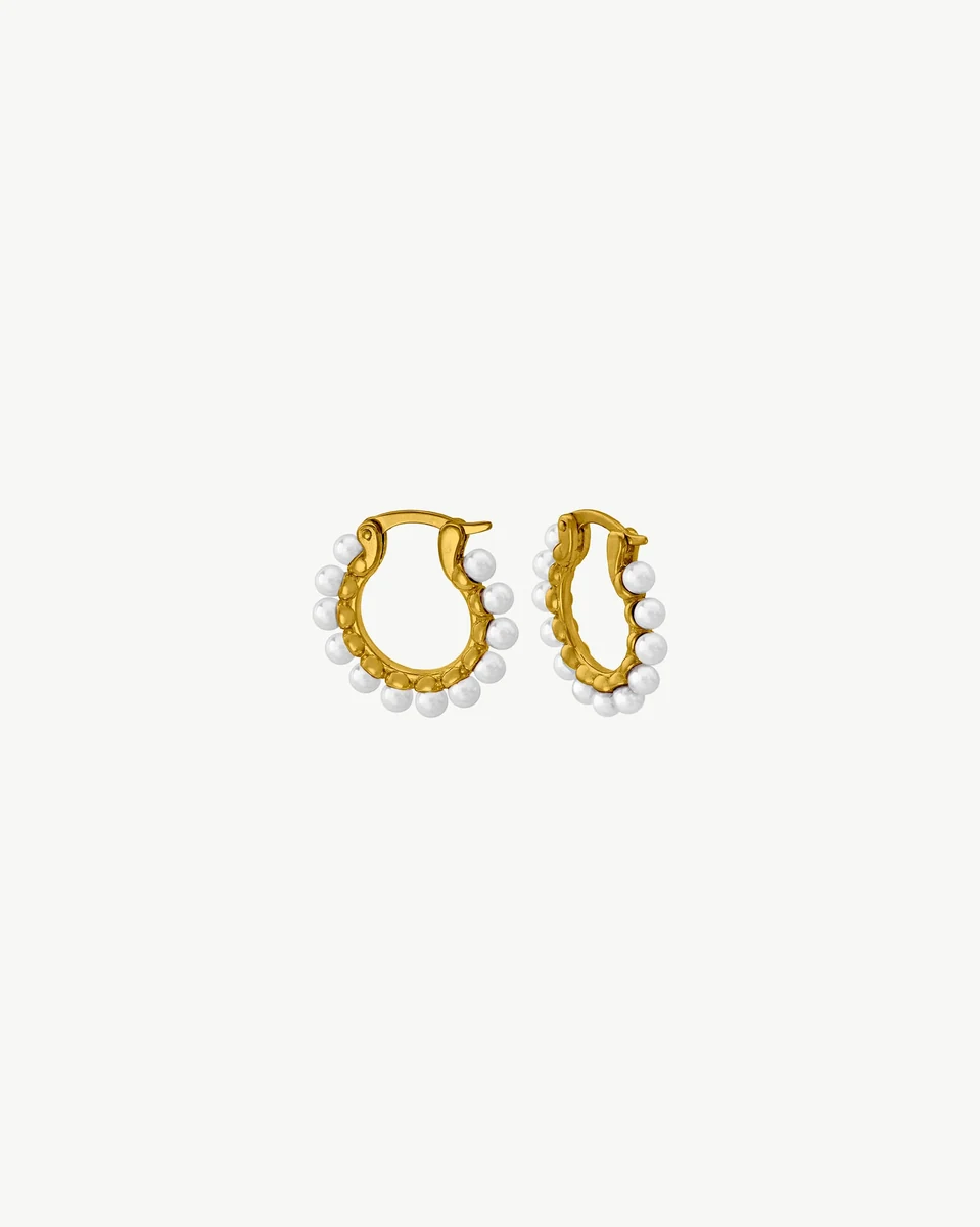Front view of gold hoop earrings with white pearls on a white background.