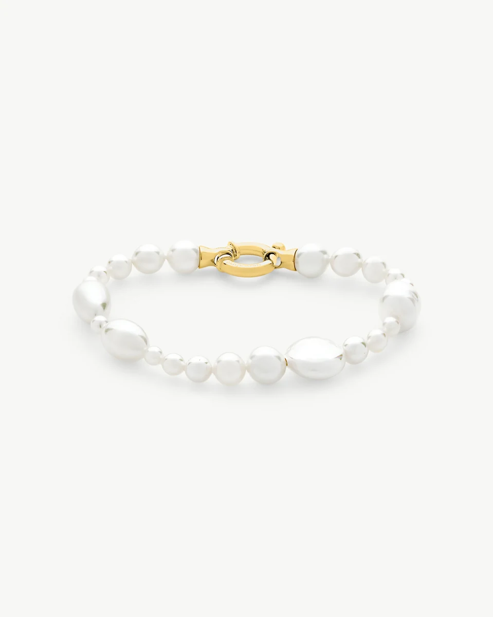White pearl bracelet with gold marine clasp, front angled view on a white background.