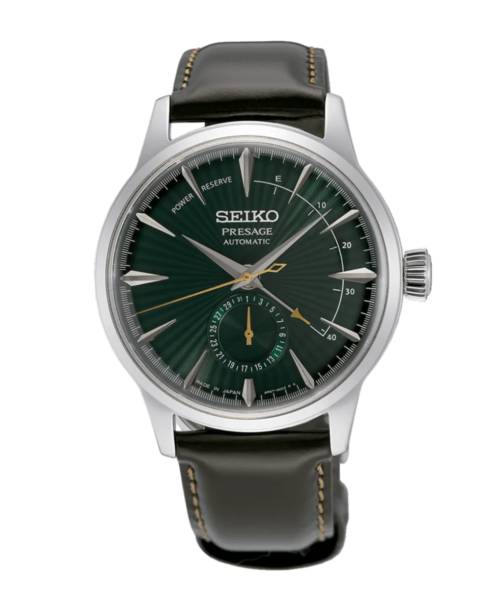 Vista frontal completa del reloj con esfera verde y correa de piel oscura sobre fondo blanco.