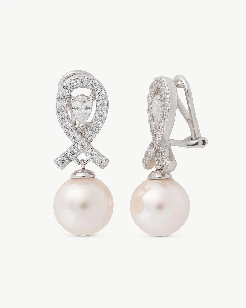 Front view of pearl drop earrings with a zircon bow detail, white background.