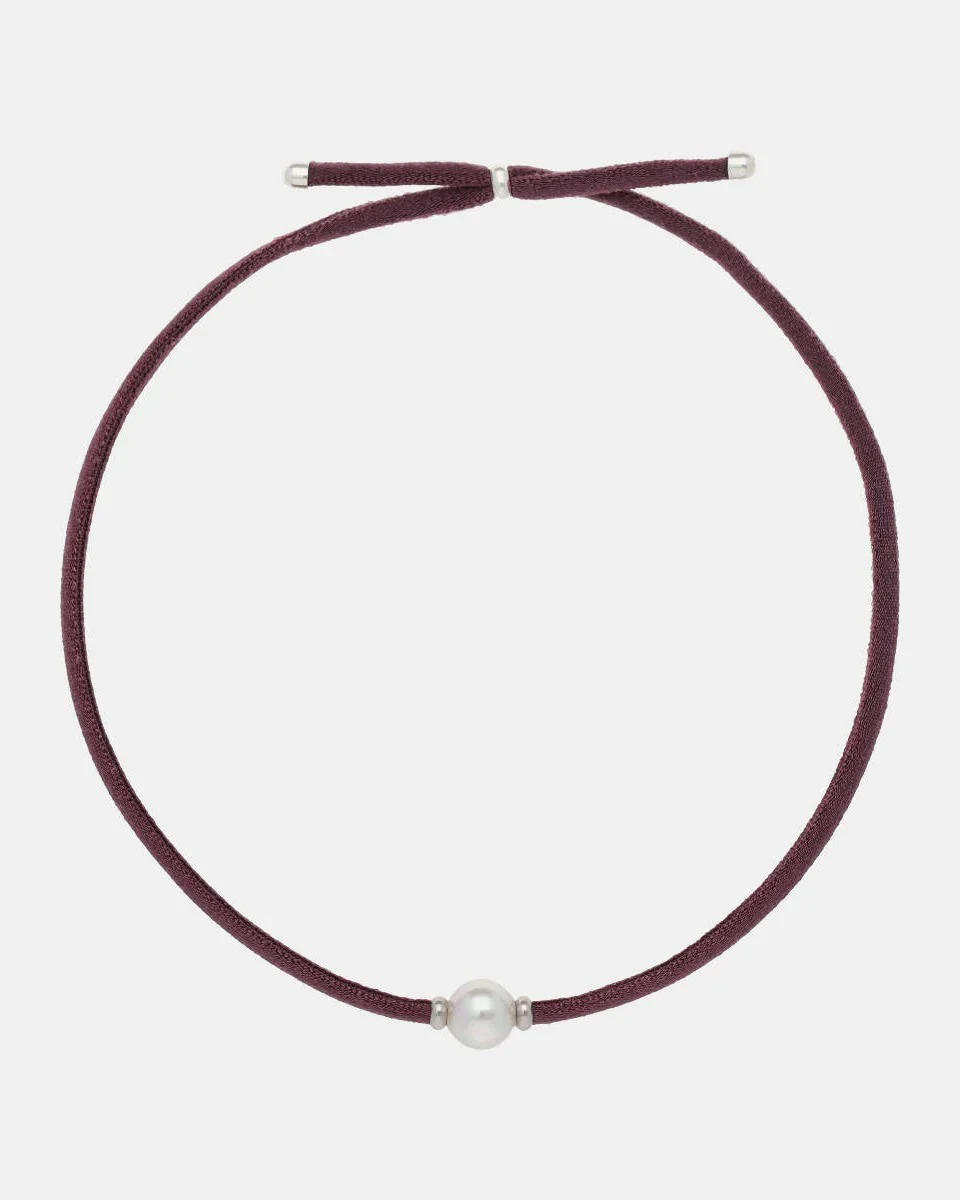 Magenta elastic necklace with white pearl, full front view on a white background.