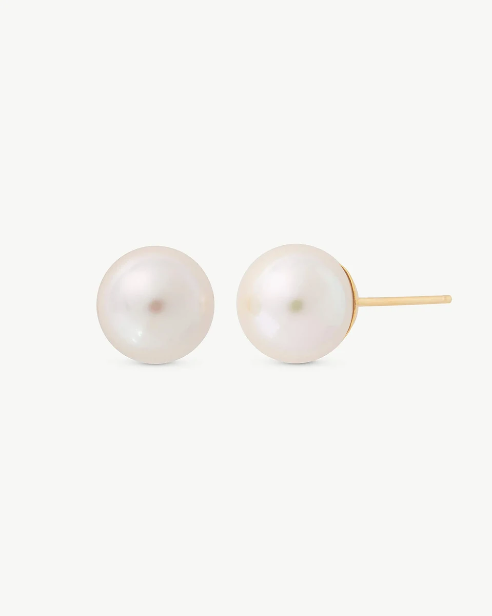 Pair of white pearl stud earrings with gold posts, front view on a white background.