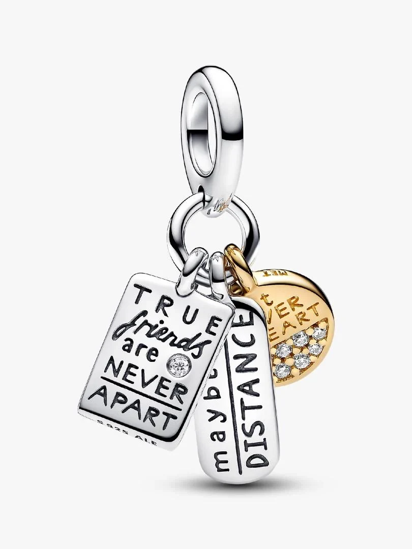 Vue frontale des trois pendentifs du charm, angle légèrement plongeant, sur fond blanc.