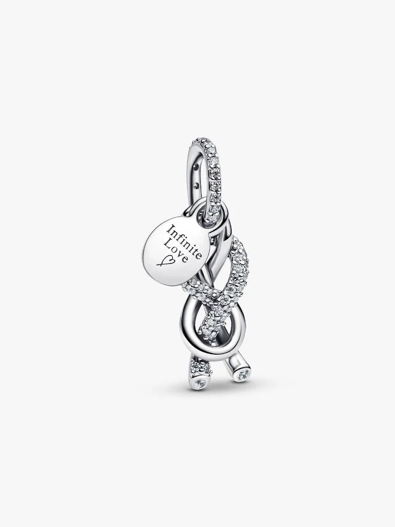 Infinity knot charm with cubic zirconia pavé, front angled view on a white background.