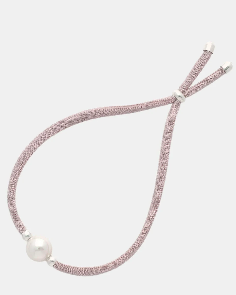Pink bracelet with central white pearl, front view on a pure white background.