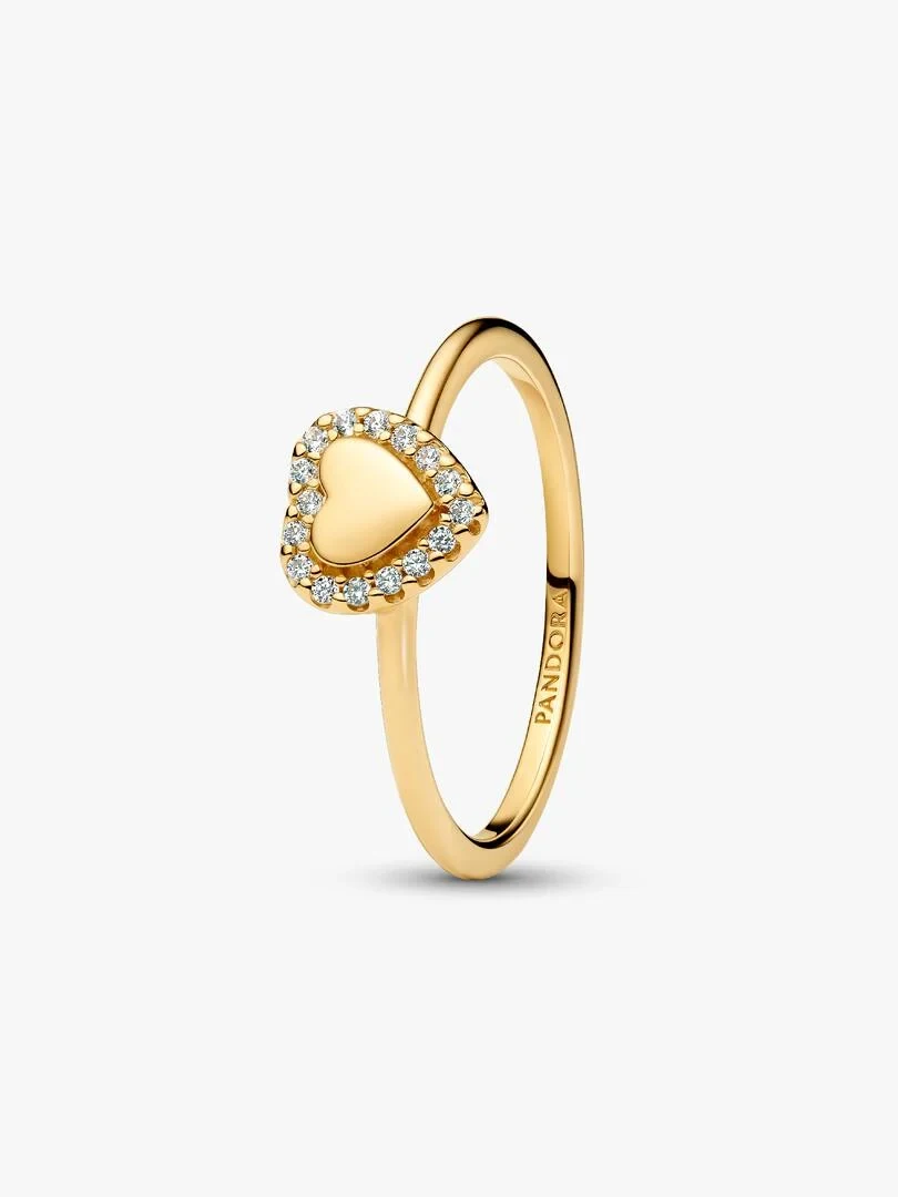 Side angle view of heart ring with cubic zirconia halo on a white background.