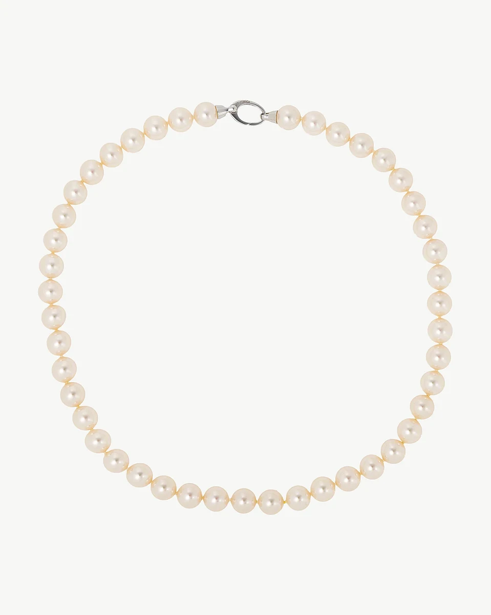 Pearl necklace arranged in a circular shape on a white background, full frontal view.