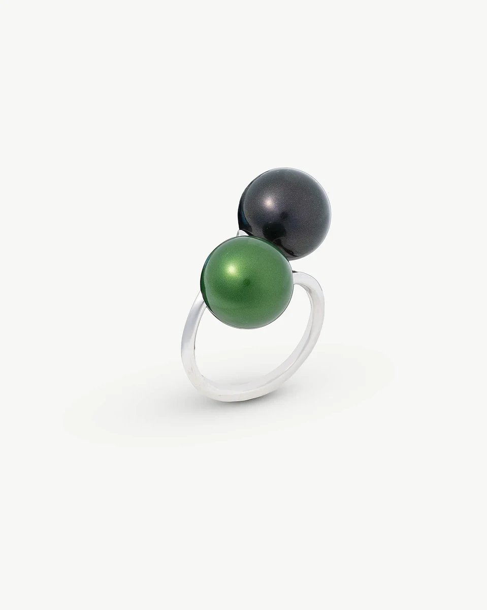Silver ring with two pearls, side angle view, on a pure white background.