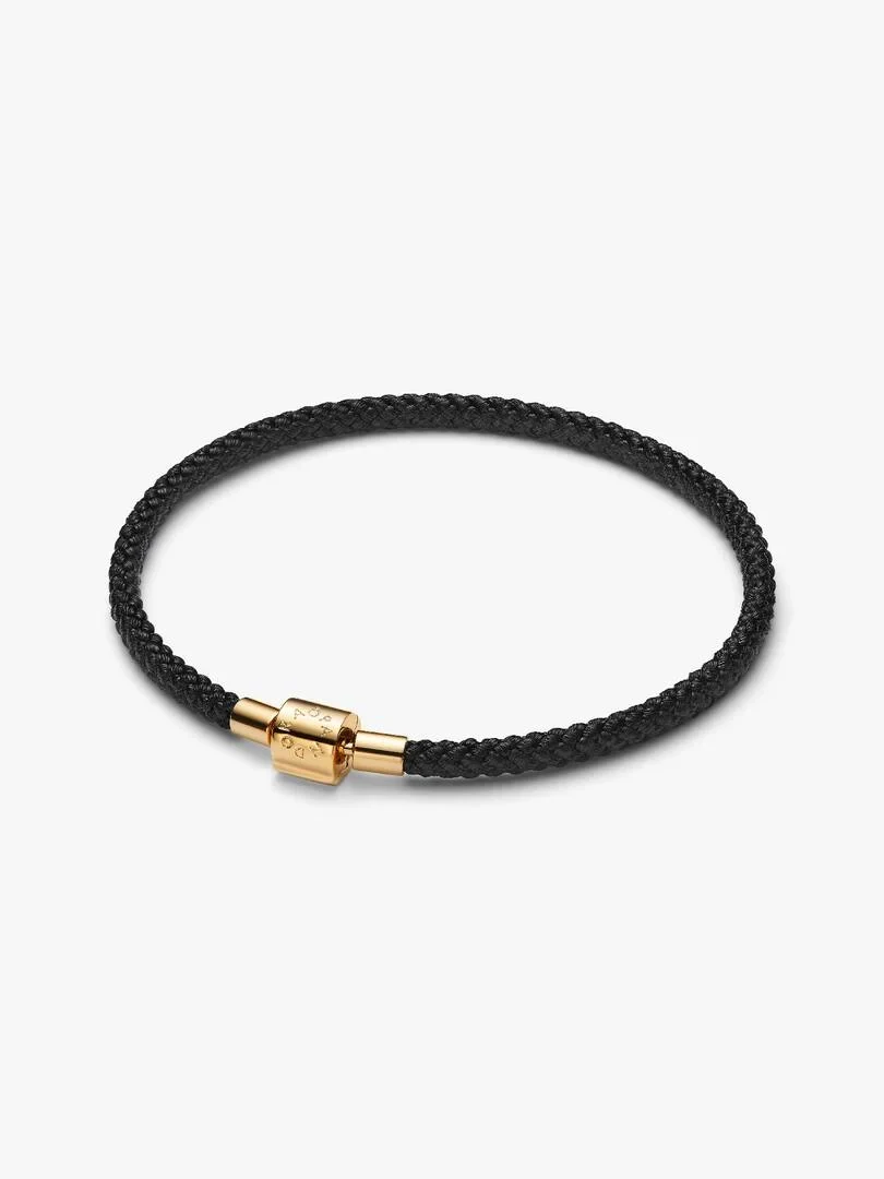 Black cord bracelet on white background, side view focusing on the 14k gold-tone clasp.