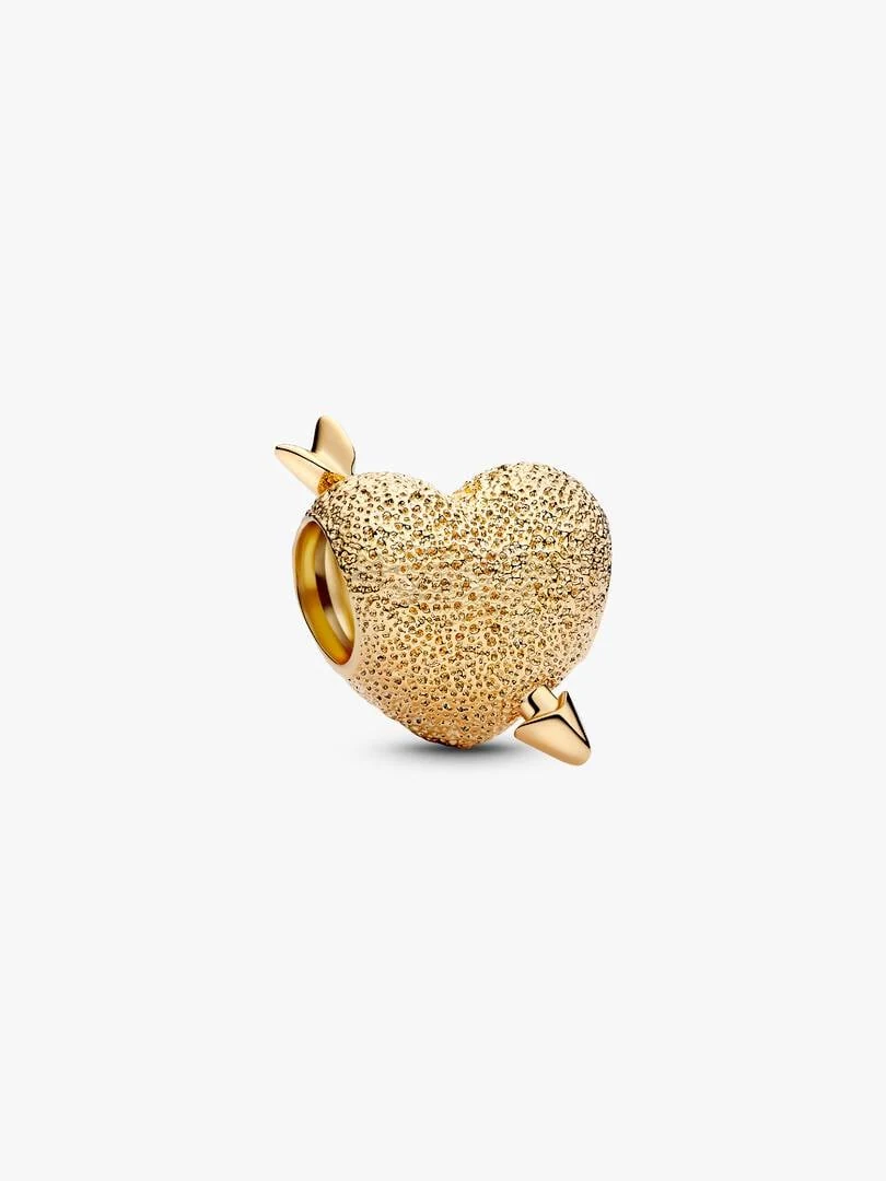 Gold-tone heart charm with diamond-cut texture and arrow, side view on a white background.