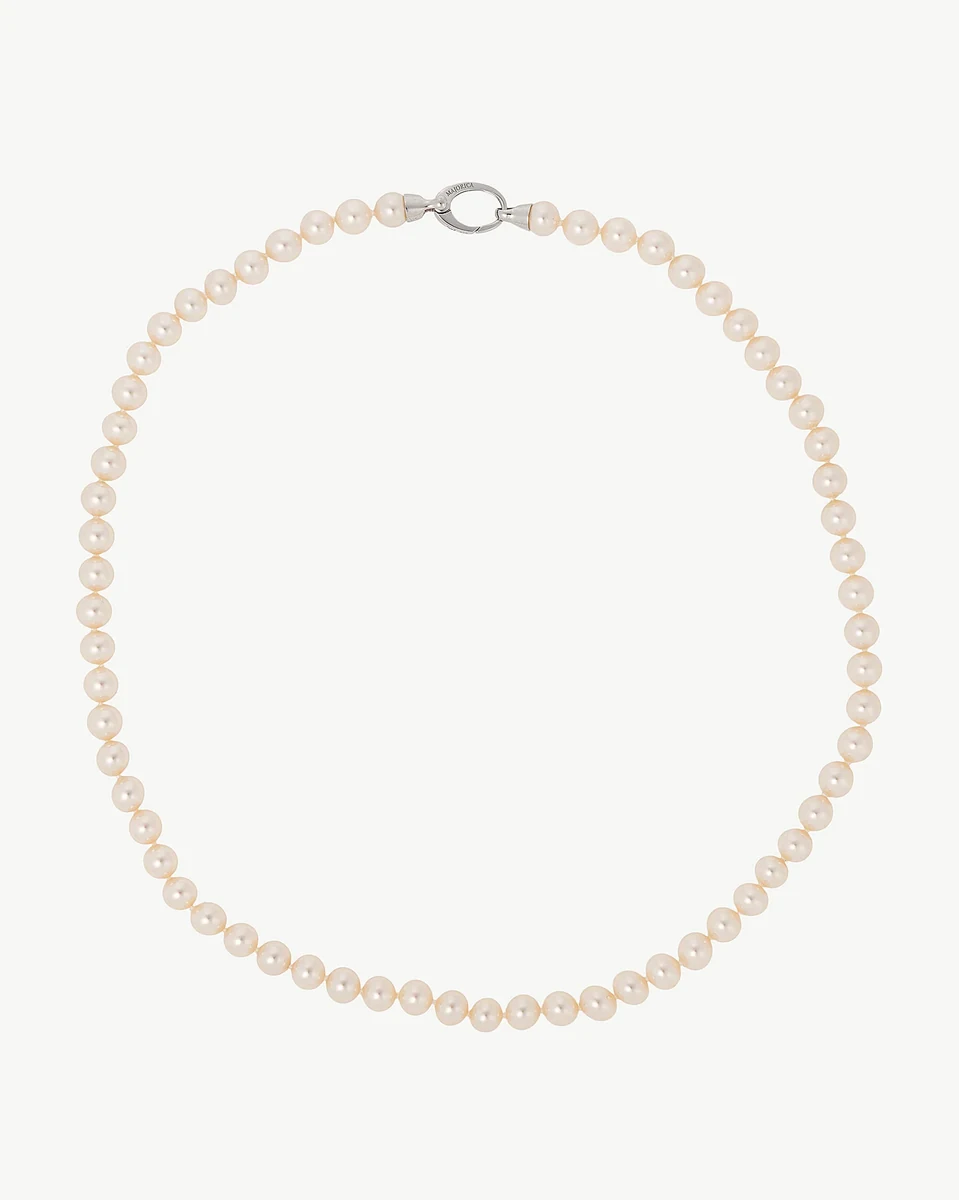 Pearl necklace arranged in a circular shape on a white background, full front view.