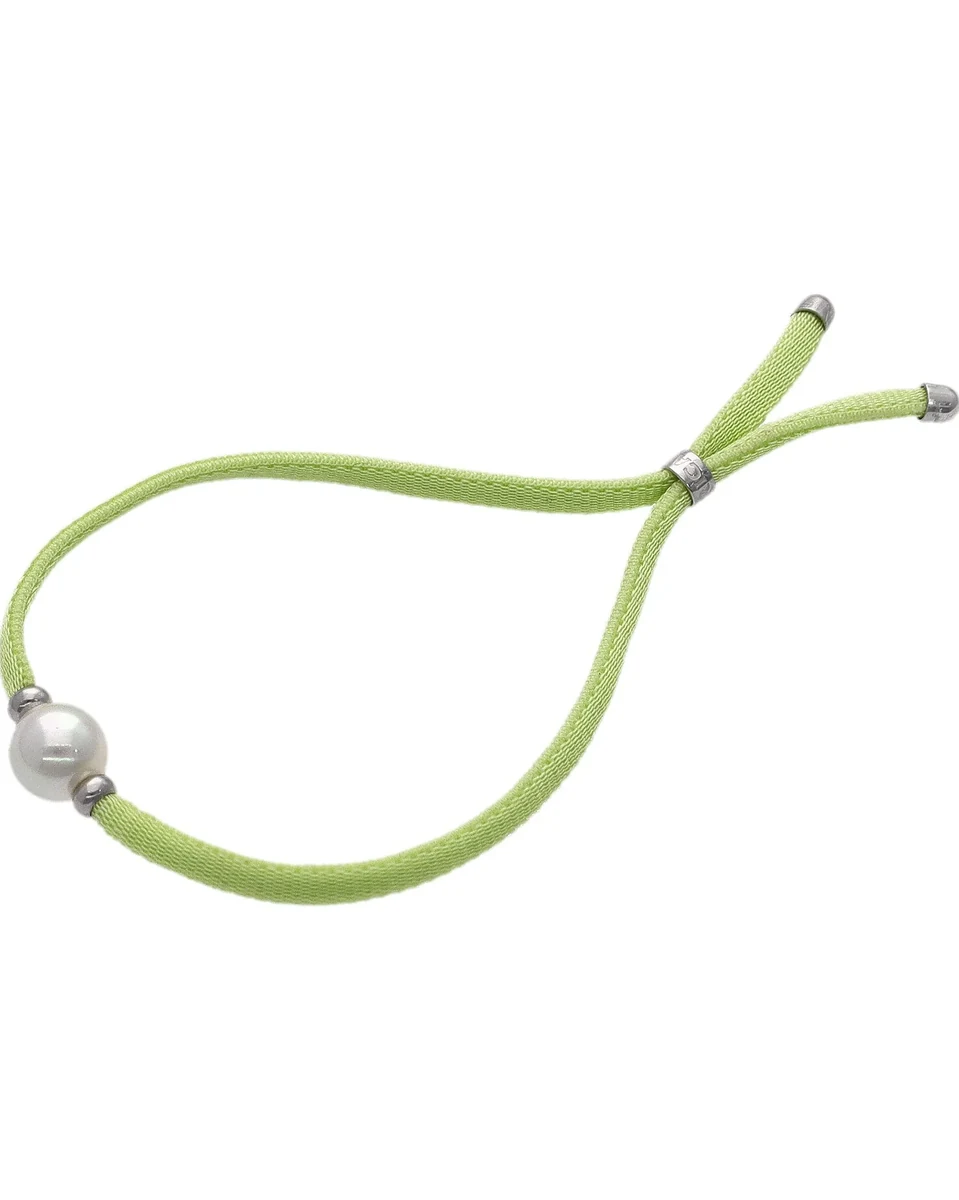 Lime green cord bracelet with white pearl, side view on a white background.