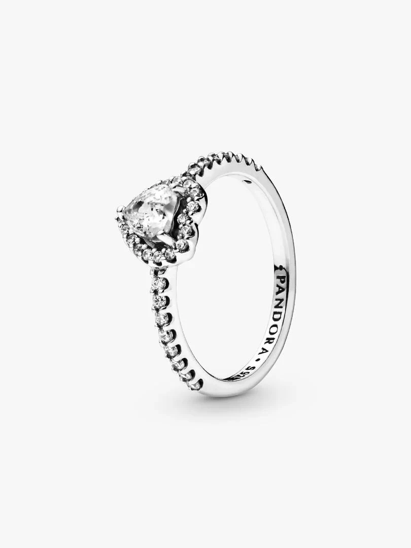 Heart ring with cubic zirconia shown from a side angle, white background, detail of the inner engraving.