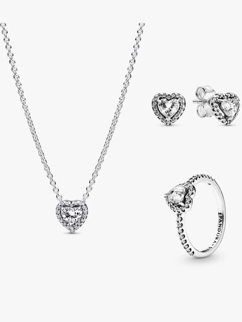 Conjunto de collar, pendientes y anillo con corazón de circonita sobre fondo blanco, vista frontal.