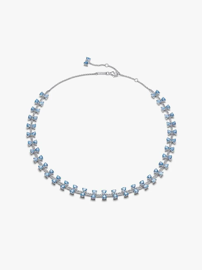 Blue bow necklace arranged in a circular shape on a white background, full front view.