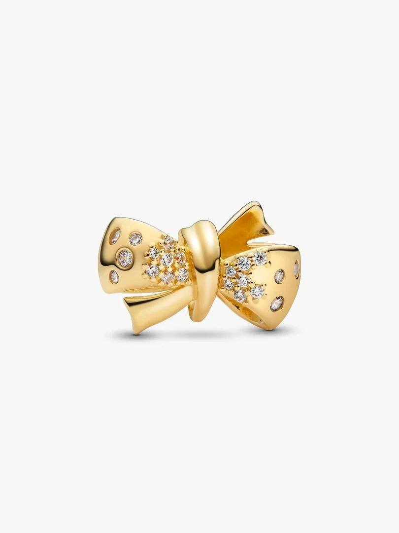 Gold bow charm with cubic zirconia, front angled view on a white background.