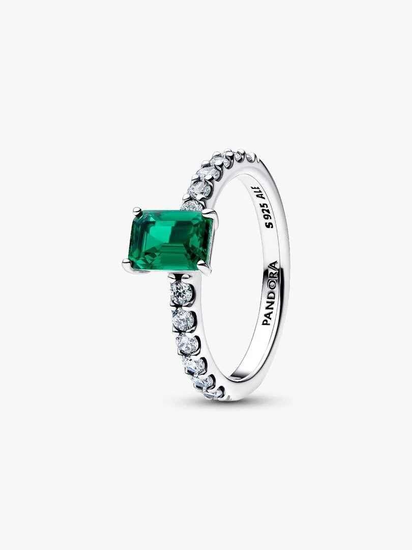 Silver ring with rectangular green stone shown from a side angle, pure white background.