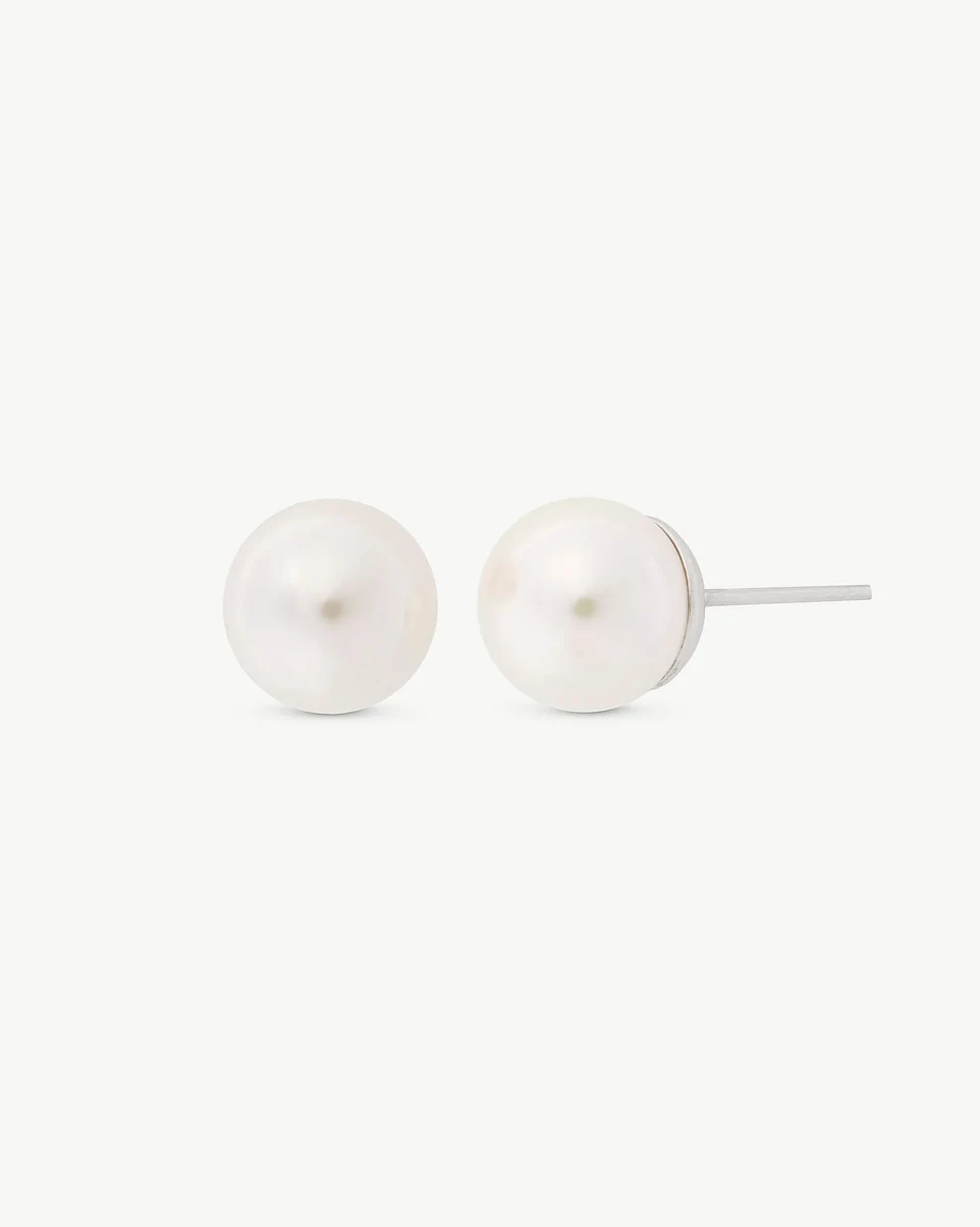 Front view of white pearl stud earrings, white background, showing the side silver post.
