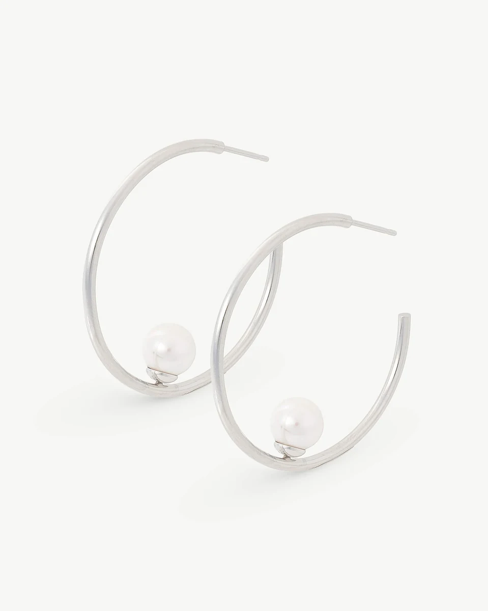 Front view of hoop earrings with pearl, slightly high-angle shot on a white background.
