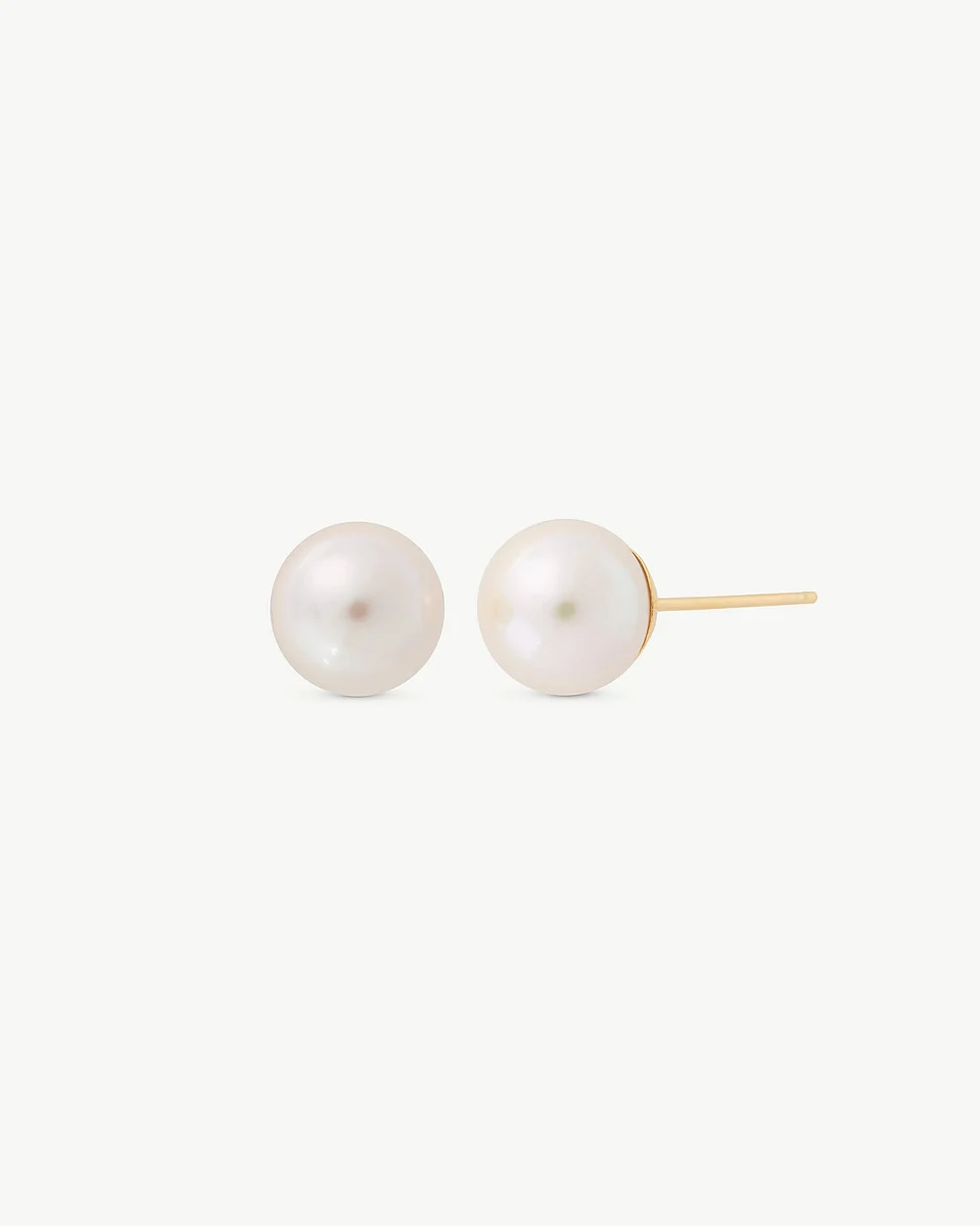 Pair of white pearl stud earrings with gold posts, front view on a white background.
