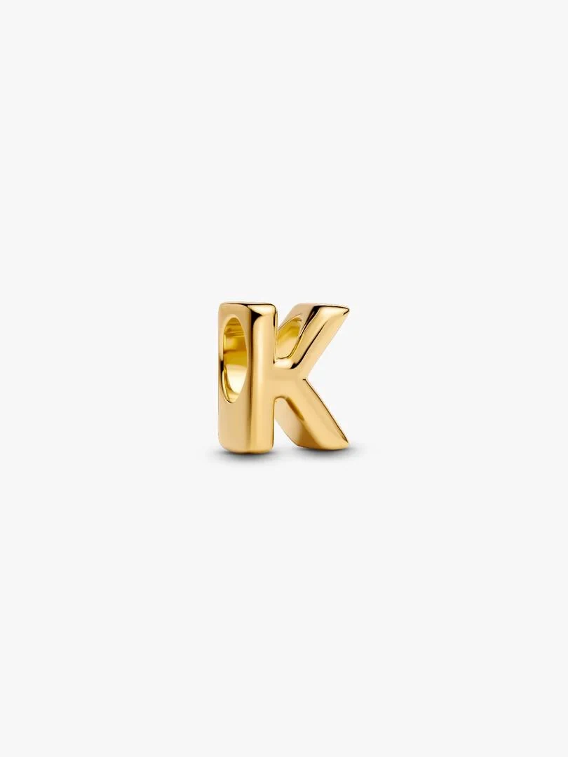 Gold-tone letter K charm, front three-quarter view on a solid white background.